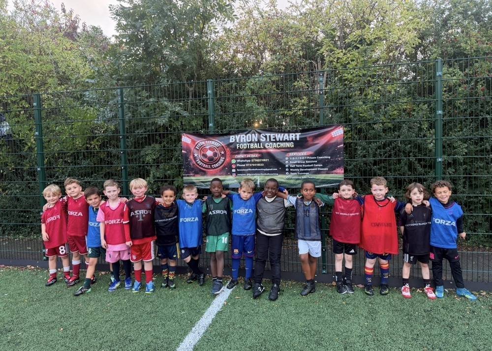 A line of young players under the coaching banner